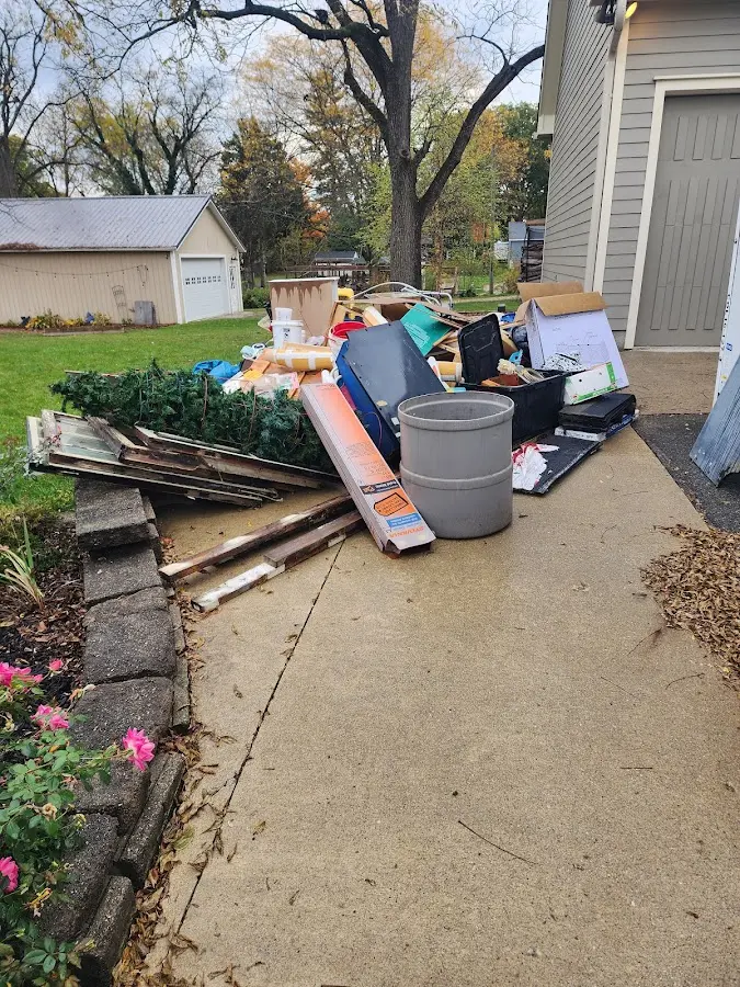Dumpster being loaded with debris for Estate Cleanout Dumpster Rental in Huntington Park